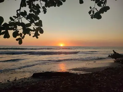 a sunset on a beach with the ocean at Casa Paraíso in Manzanillo