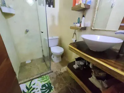 a bathroom with a sink and a shower and a toilet at Casa Paraíso in Manzanillo