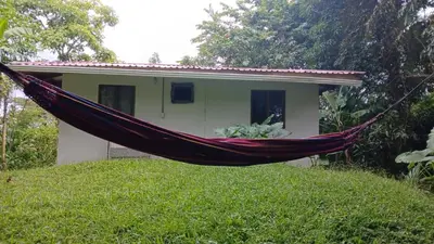 a hammock in front of a house at Casa Paraíso in Manzanillo