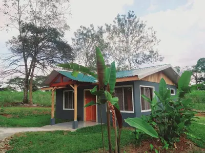 a small house in the middle of a field at Escapadita Pura Vida in Fortuna