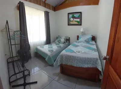 a small bedroom with a bed and a window at Escapadita Pura Vida in Fortuna
