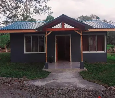 a small house with a porch and a door at Escapadita Pura Vida in Fortuna