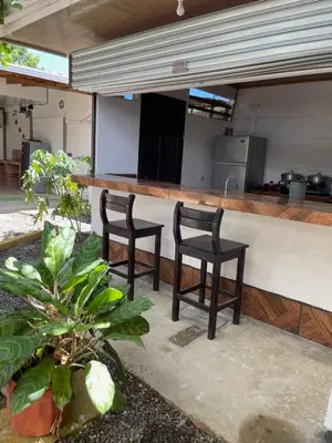 two chairs sitting at a bar in a kitchen at Casa Grande Villas Ela en Bahía Ballena in Uvita