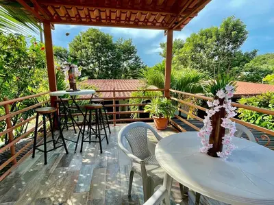 a patio with a table and chairs on a deck at Casa Grande Villas Ela en Bahía Ballena in Uvita