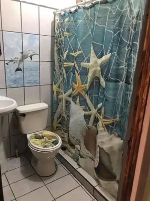 a bathroom with a toilet and a shower curtain at Casa Grande Villas Ela en Bahía Ballena in Uvita