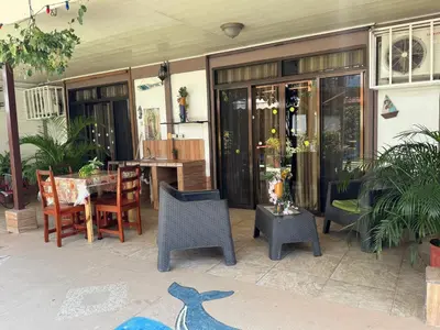 a patio with a table and chairs and a dining room at Casa Grande Villas Ela en Bahía Ballena in Uvita