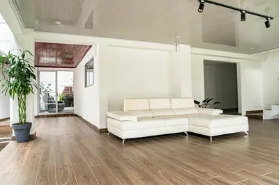 a living room with a white couch and wooden floors at home 333 habitacion 332 in Escazu