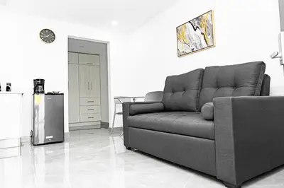 a living room with a couch and a refrigerator at home 333 habitacion 332 in Escazu
