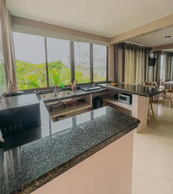 a kitchen with two sinks and a large window at Tinajas Arenal Lakefront Lodge in Nuevo Arenal