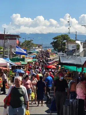 a large crowd of people walking through a market at BnB Ecostay in San José