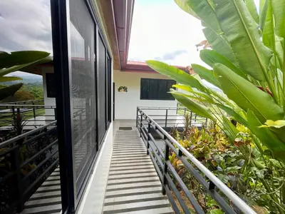 a balcony of a house with some plants at Villas Pura Vida in Ojochal