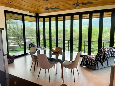 a dining room with a table and chairs at Villas Pura Vida in Ojochal