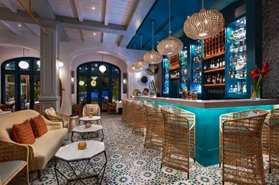 a bar in a restaurant with chairs and a bar counter at Las Catalinas Doorway in Playa Flamingo