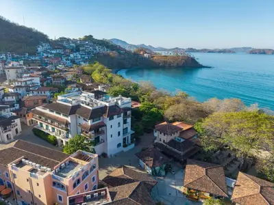 an aerial view of a town next to the water at Las Catalinas Doorway in Playa Flamingo
