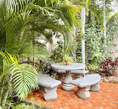 a patio with a table and two benches at Olas de Oro in Nicoya