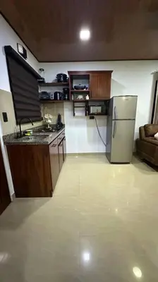 a kitchen with a stainless steel refrigerator in a room at Casita Oropéndola in Monterrey