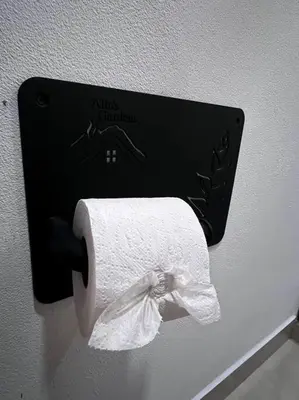 a towel dispenser with a roll of toilet paper at Casita Oropéndola in Monterrey