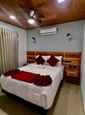 a bedroom with a bed and a ceiling fan at Casita Oropéndola in Monterrey