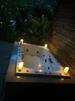 a bathroom with a bath tub with lights on it at Casita Oropéndola in Monterrey