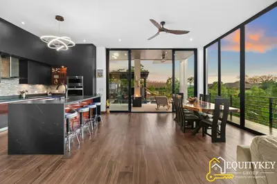 a kitchen and dining room with a table and chairs at Casa Luna Amarillo - Your Pacific Escape! in Playa Hermosa