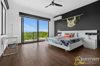 a bedroom with a bed and a large window at Casa Luna Amarillo - Your Pacific Escape! in Playa Hermosa