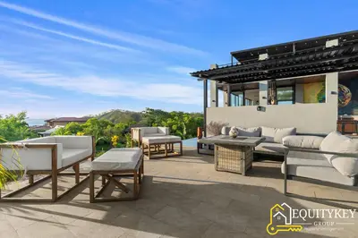 a patio with couches and a table and chairs at Casa Luna Amarillo - Your Pacific Escape! in Playa Hermosa