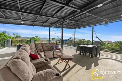 a living room with a couch and a table at Casa Luna Amarillo - Your Pacific Escape! in Playa Hermosa