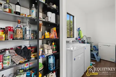 a pantry filled with lots of bottles and a sink at Casa Luna Amarillo - Your Pacific Escape! in Playa Hermosa