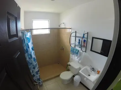 a bathroom with a shower and a toilet and a sink at Casa Las Palmas Playa Bejuco in Bejuco