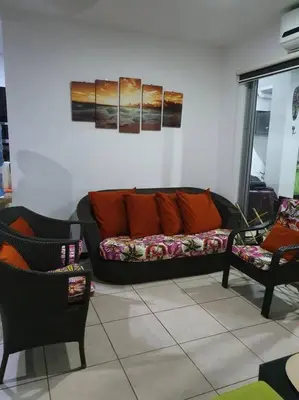 a living room with a couch and two chairs at Casa Las Palmas Playa Bejuco in Bejuco