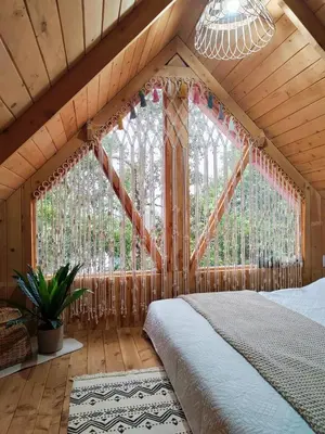 a bedroom with a bed and a large window at Cabaña Lugar de Paz in División
