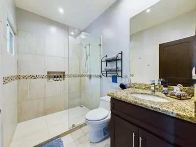 a bathroom with a shower and a toilet and a sink at Casa Rebanada De Vida in Brasilito