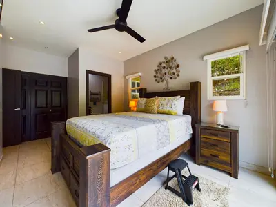 a bedroom with a large bed and a window at Casa Rebanada De Vida in Brasilito