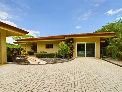 a house with a brick driveway in front of it at Casa Rebanada De Vida in Brasilito