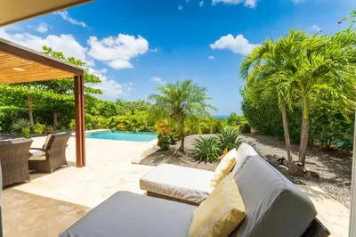 a patio with a couch and a swimming pool at Casa Rebanada De Vida in Brasilito