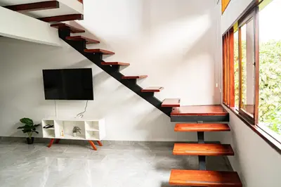 a living room with a staircase with a flat screen tv at home 333 loft 334 in Escazu