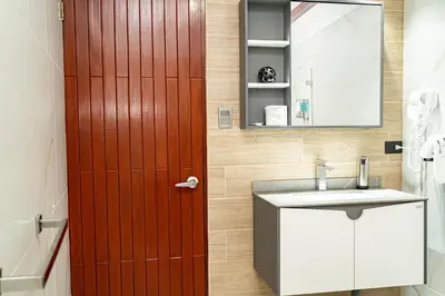 a bathroom with a red door and a sink at home 333 loft 334 in Escazu