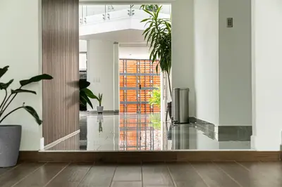 an empty lobby with plants and a glass door at home 333 loft 334 in Escazu