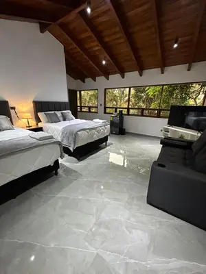 a large bedroom with two beds and a couch at home 333 habitacion 335 in Escazu