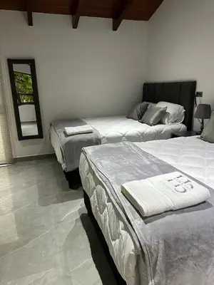 a bedroom with three beds in a room at home 333 habitacion 335 in Escazu