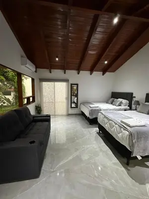 a living room with two beds and a couch at home 333 habitacion 335 in Escazu