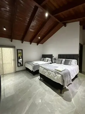 a bedroom with two beds and a wooden ceiling at home 333 habitacion 335 in Escazu