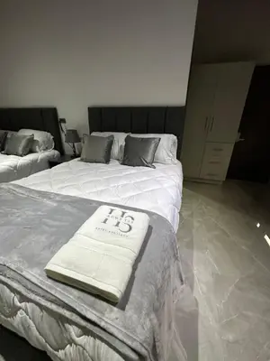 two beds with towels on them in a room at home 333 habitacion 335 in Escazu