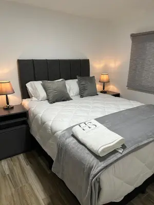 a bedroom with a large bed with two lamps at home 333 habitacion 337 in Escazu