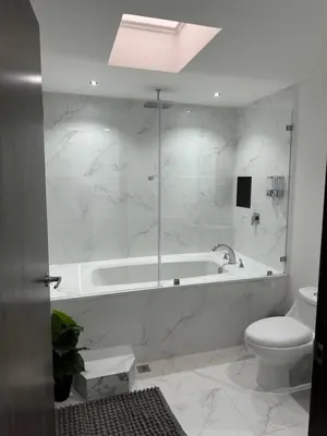 a white bathroom with a tub and a toilet at home 333 habitacion 337 in Escazu