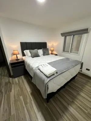 a bedroom with a large bed with two lamps at home 333 habitacion 337 in Escazu