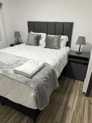 a bedroom with a large bed with two night stands at home 333 habitacion 337 in Escazu