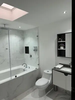 a bathroom with a tub and a toilet and a sink at home 333 habitacion 337 in Escazu