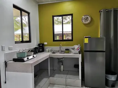 a kitchen with a sink and a refrigerator at Susan Bungalow#1 Bahía Drake, Corcovado Familia Amaya in San Pedrillo
