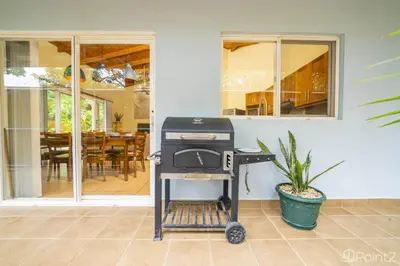 a grill on a cart in front of a house at Beautiful 2-BR House Steps from the Beach in Playa Flamingo